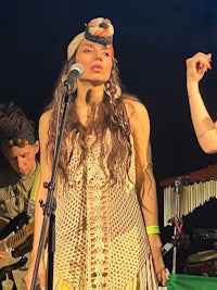 two women singing in front of a microphone