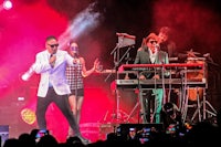 a group of people on stage at a concert