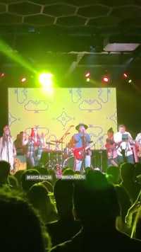 a group of people on stage at a concert