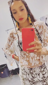 a woman taking a selfie in a lace dress